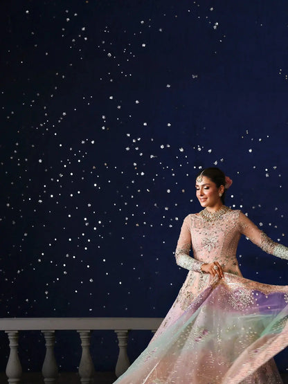 Woman in a sparkling dress against a starry night sky